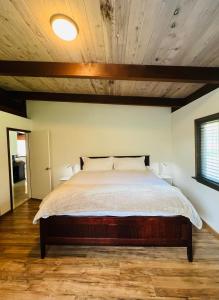 a bedroom with a bed with a wooden ceiling at Pacific Sands Vacation Home by Vynmir in Fort Bragg