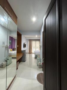 a bathroom with a glass door to a room at ANNIE KUCA in Jakarta