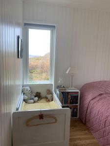 a childs bedroom with a bed and two stuffed animals at Unique private cabin in Lofoten in Leknes