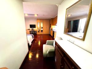 a hotel room with a bed and a mirror at Collection O The Step Sathorn in Bangkok