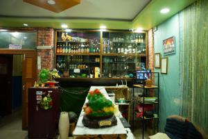 a bar with a table with a cake on it at Universal Hotel & Lodge - Gorkha in Gorkhā