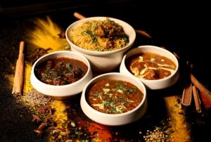 a group of four bowls of food on a table at Le Méridien Phuket Mai Khao Beach Resort in Mai Khao Beach