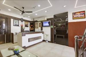 a living room with a fireplace and a tv at RTS Hotel Delhi Airport in New Delhi