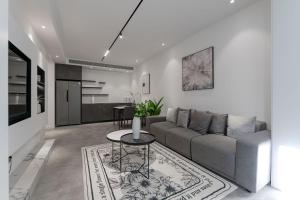 a living room with a couch and a table at Deluxe One-bedroom Apartment Black and White Gray Modern Style Designer Brand Central Air Conditioning in Shanghai