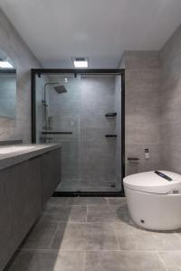 a bathroom with a shower and a toilet and a tub at Brand New Apartment The Bund Nanjing Road Xintiandi Cheng Huangmiao Large Flat Warm and Sunny Three Rooms 100m from Metro Station in Shanghai
