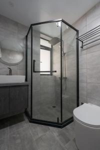 a bathroom with a shower and a toilet and a sink at Brand New Apartment The Bund Nanjing Road Xintiandi Cheng Huangmiao Large Flat Warm and Sunny Three Rooms 100m from Metro Station in Shanghai