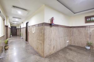 a hallway with wooden walls in a room with potted plants at RTS Hotel Delhi Airport in New Delhi