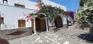 a white building with a bunch of flowers on it at Hotel Palladion in Karterados