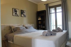 a bedroom with a large bed with towels on it at Elatos Sea House in Kato Gatzea