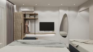 ein Schlafzimmer mit einem Bett und einem TV an der Wand in der Unterkunft Hotel Areti in Neos Marmaras