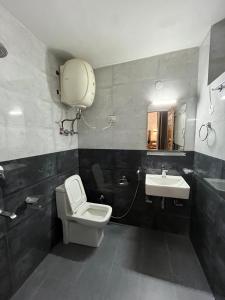 a bathroom with a toilet and a sink at Hotel Premier Mall Road Manali in Manāli
