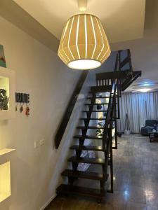 a staircase in a house with a chandelier at ORANGE ISLAND in Lagos