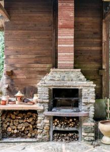 an outdoor brick oven with a pile of logs at La pace dei sensi in Maida