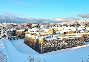 a city covered in snow with buildings at Apartamentos Jaca Ciudadela 3000 in Jaca