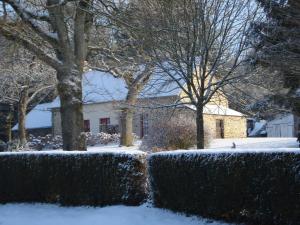 a snow covered yard with trees and a house at House with stunning views across the meadows in Bonnemain
