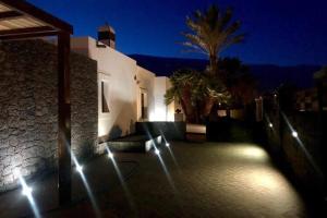 a building with lights on the side of it at night at Beautiful holiday home in Playa Blanca with pool in Playa Blanca