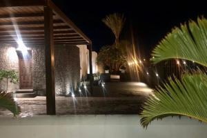 a night view of a house with a fountain at Beautiful holiday home in Playa Blanca with pool in Playa Blanca