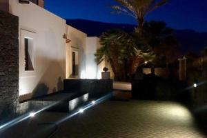 a house with lights on the side of it at night at Beautiful holiday home in Playa Blanca with pool in Playa Blanca