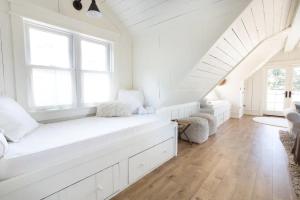 a white room with a white bench in a room with windows at Anavo Farm’s Chic Sheep Retreat in Solvang