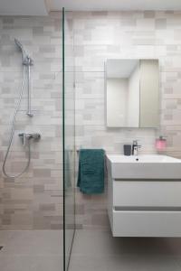 a bathroom with a sink and a mirror and a shower at Modern & Stylish Apartment Close to Tigne Point - Close to Saint Julians & Valletta Ferry in Sliema +28 photos