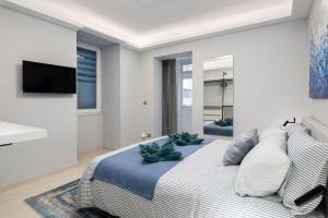 a bedroom with a bed with two plants on it at Modern & Stylish Apartment Close to Tigne Point - Close to Saint Julians & Valletta Ferry in Sliema