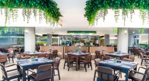 een restaurant met tafels en stoelen en een bar bij A-ONE Pattaya Beach Resort in Pattaya