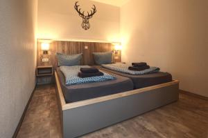 two twin beds in a room with lights on at Haus Susanne in Oberhof