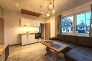 a living room with a couch and a table at Haus Susanne in Oberhof