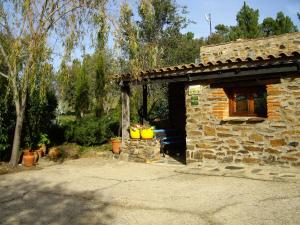 a stone building with a bench in front of it at Modern Farmhouse in Valencia de Alc ntara with Pool in La Borrega