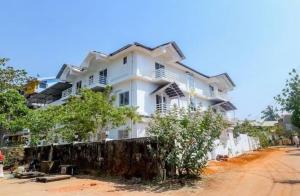 a white building on the side of a street at Hotel Vaibhav Hill Park in Mapusa