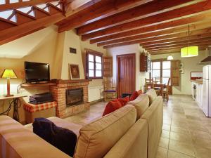 a living room with a couch and a fireplace at Belvilla by OYO Cottage in Nava with Swimming Pool in Nava