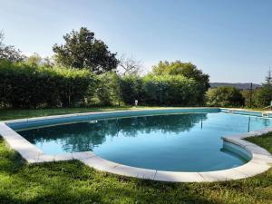 a swimming pool in the grass in a yard at Belvilla by OYO Cottage in Nava with Swimming Pool in Nava