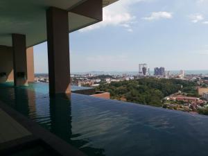 a swimming pool on the roof of a building with a view at APPLE CloverLeafs Homestay Melaka in Melaka