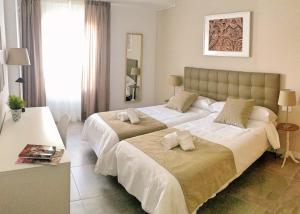 Postel nebo postele na pokoji v ubytování Balcon de la Aurora
