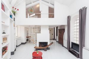a living room with a fireplace and a staircase at Prati Belfiore Guesthouse in Rome