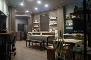 a room with a kitchen with a table and chairs at Art and Stay in Suncheon