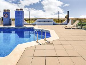a swimming pool on the roof of a house at Comfortable apartment at only 100 metres from the sea in Deltebre