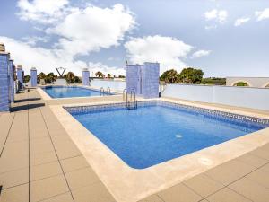 a swimming pool on the roof of a building at Comfortable apartment at only 100 metres from the sea in Deltebre