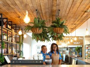 two women standing at a counter in a restaurant at Formosa Bay in Plettenberg Bay