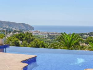 a swimming pool with a view of the ocean at Unique villa in Moraira with infinity pool in Moraira
