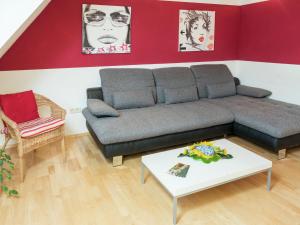 a living room with a couch and a table at Cozy Apartment in Schwenningen with Garden in Villingen-Schwenningen