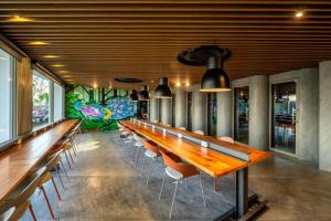 a row of tables and chairs in a restaurant at HOMA Cherngtalay Phuket in Bang Tao Beach