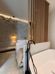 a bedroom with two beds and a wall at Poema Antiparos in Antiparos