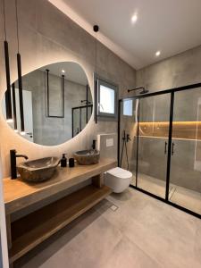 a bathroom with two sinks and a mirror at Poema Antiparos in Antiparos