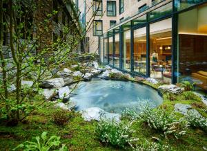 einen kleinen Pool mit Wasser in einem Garten vor einem Gebäude in der Unterkunft The Chancery Hotel in Dublin