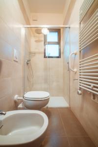 a bathroom with a toilet and a shower and a sink at La Casa di Vittoria Apartment Sea View - Housea in Polignano a Mare +16 photos