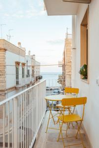 a balcony with a table and chairs and the ocean at La Casa di Vittoria Apartment Sea View - Housea in Polignano a Mare