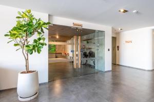 a potted plant in a hallway with a bathroom at HOMA Cherngtalay Phuket in Bang Tao Beach