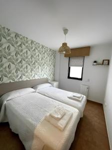 En eller flere senge i et værelse på Fisterra. Primera línea playa Langosteira