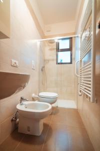 a bathroom with a toilet and a glass shower at La Casa di Vittoria Apartment Sea View - Housea in Polignano a Mare
